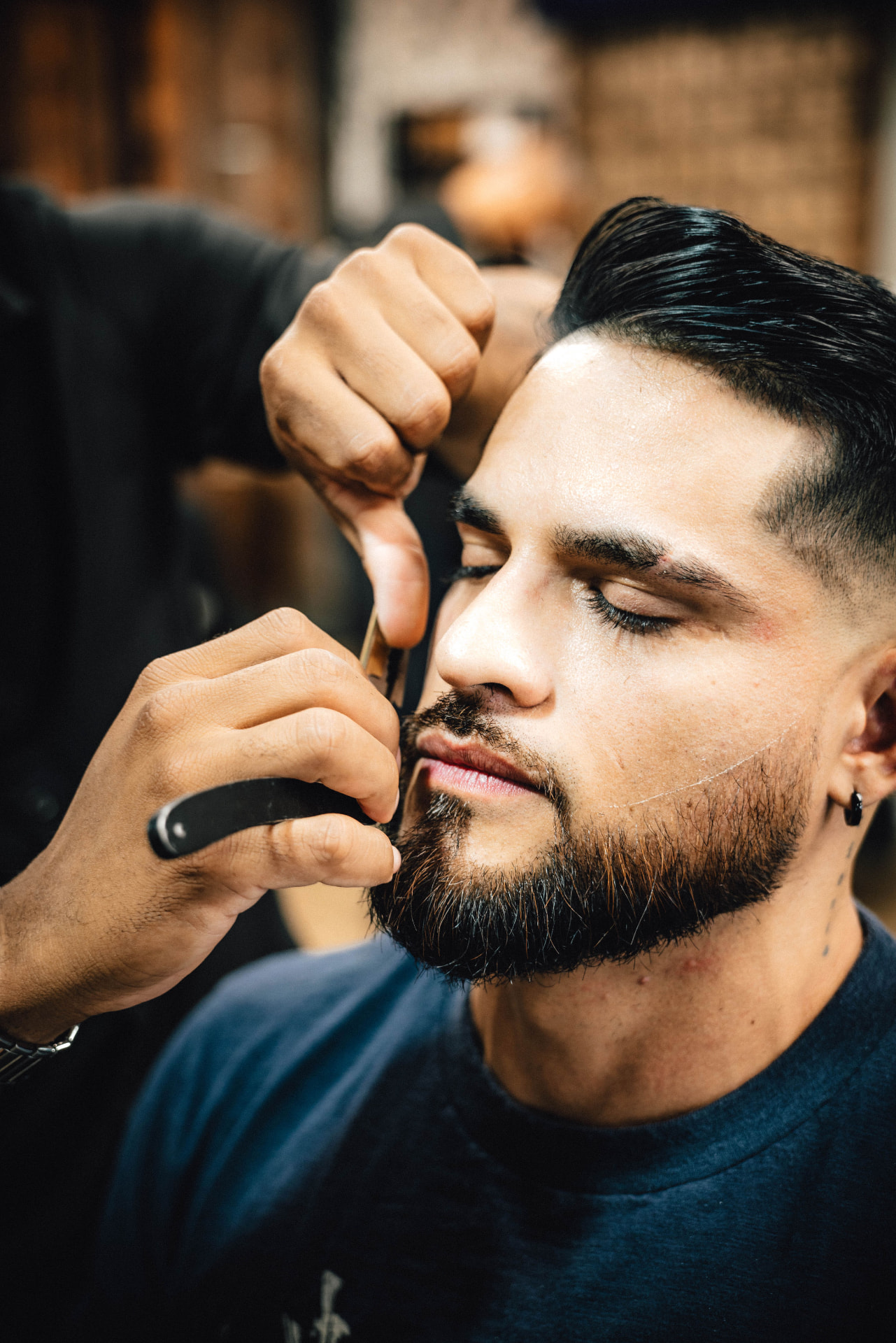Underground barber performing a straight-razor finish